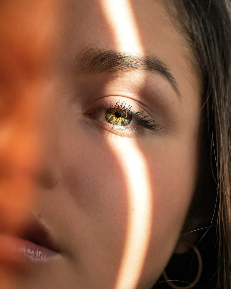 A face crossed by a single line of morning light